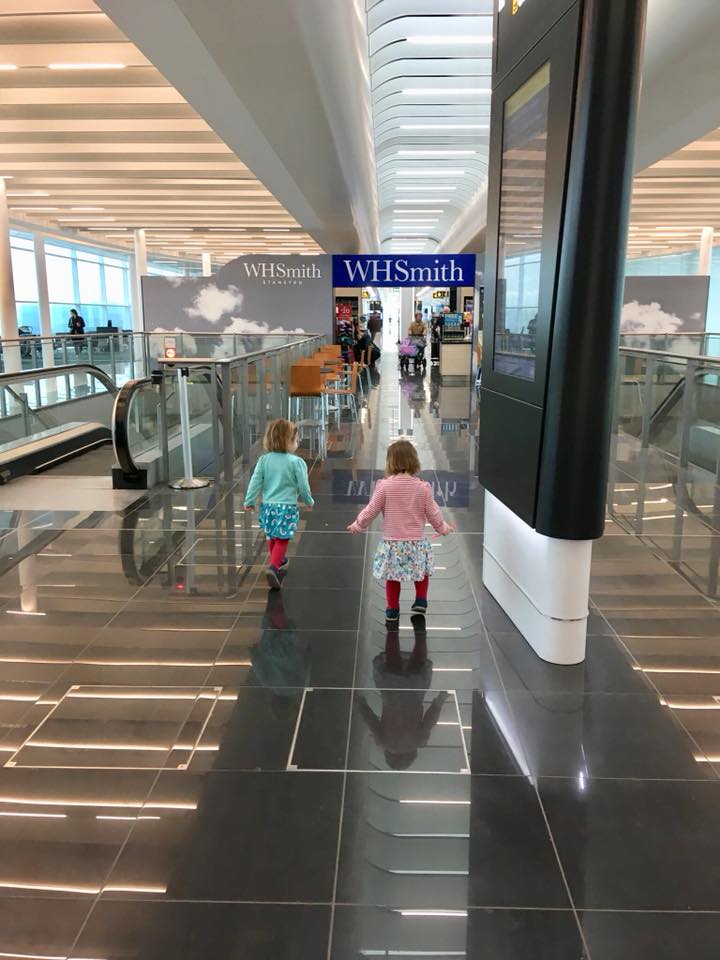 twins running off some energy in the airport