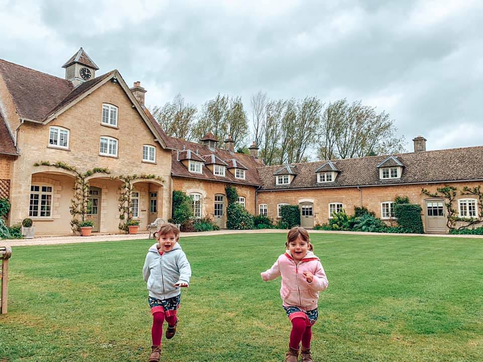 Children running on the green at Bruern Luxury Holiday Cottages