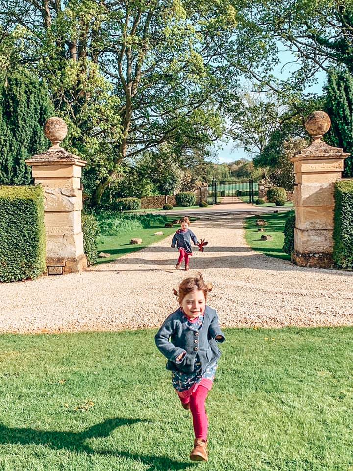 Twins running towards Bruern Cottages