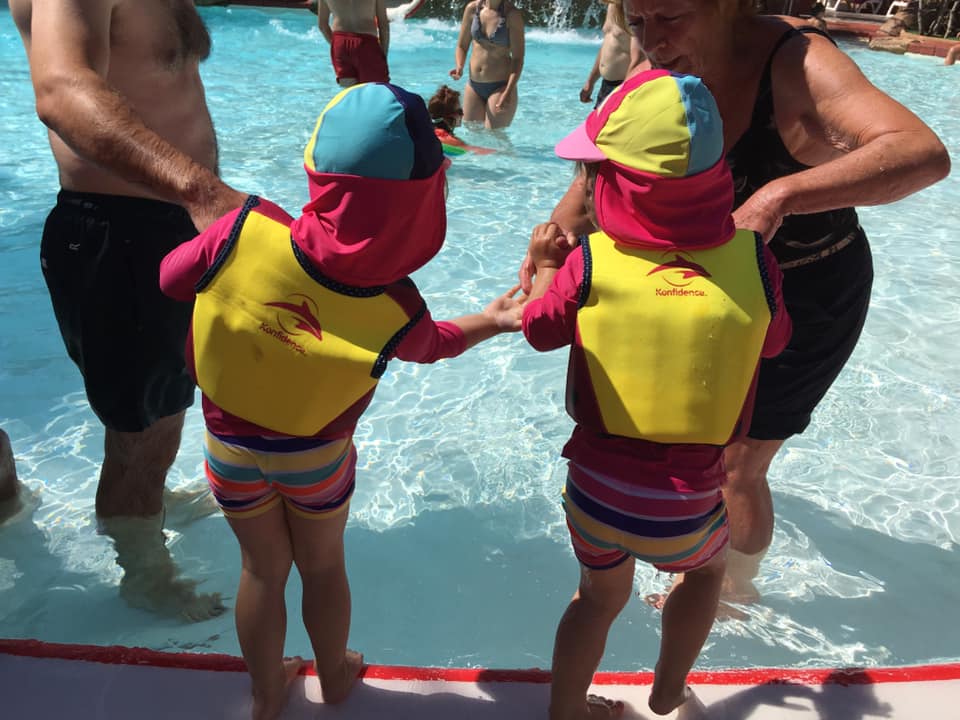 Twins wearing sun hats