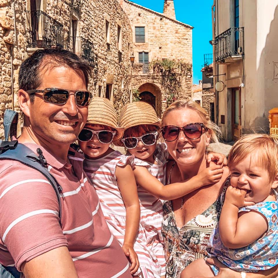 Family photo of mummy, daddy, twin girls and a baby in Pals, cobbled streets in Spain