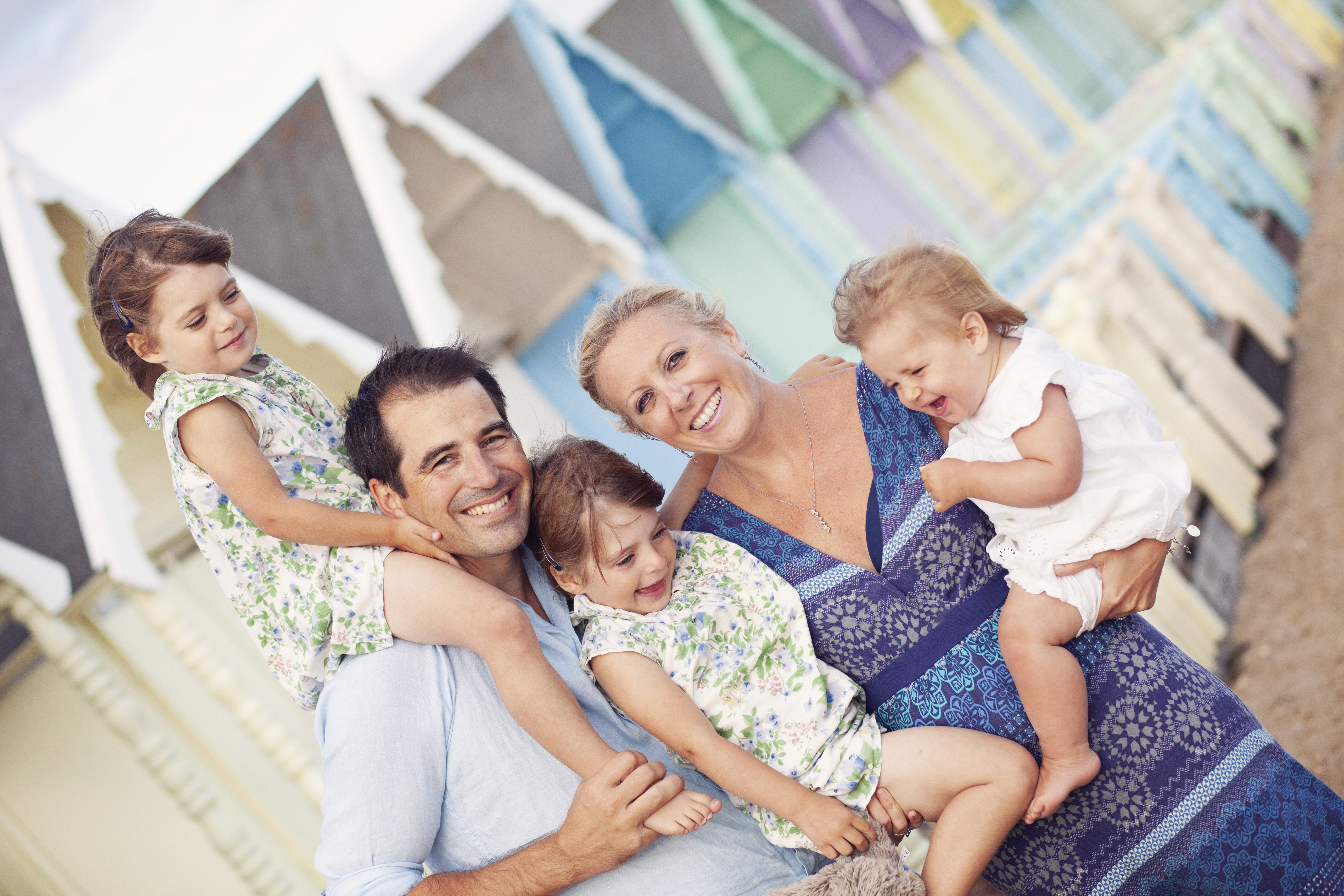 family photoshoot with beach huts as a backdrop