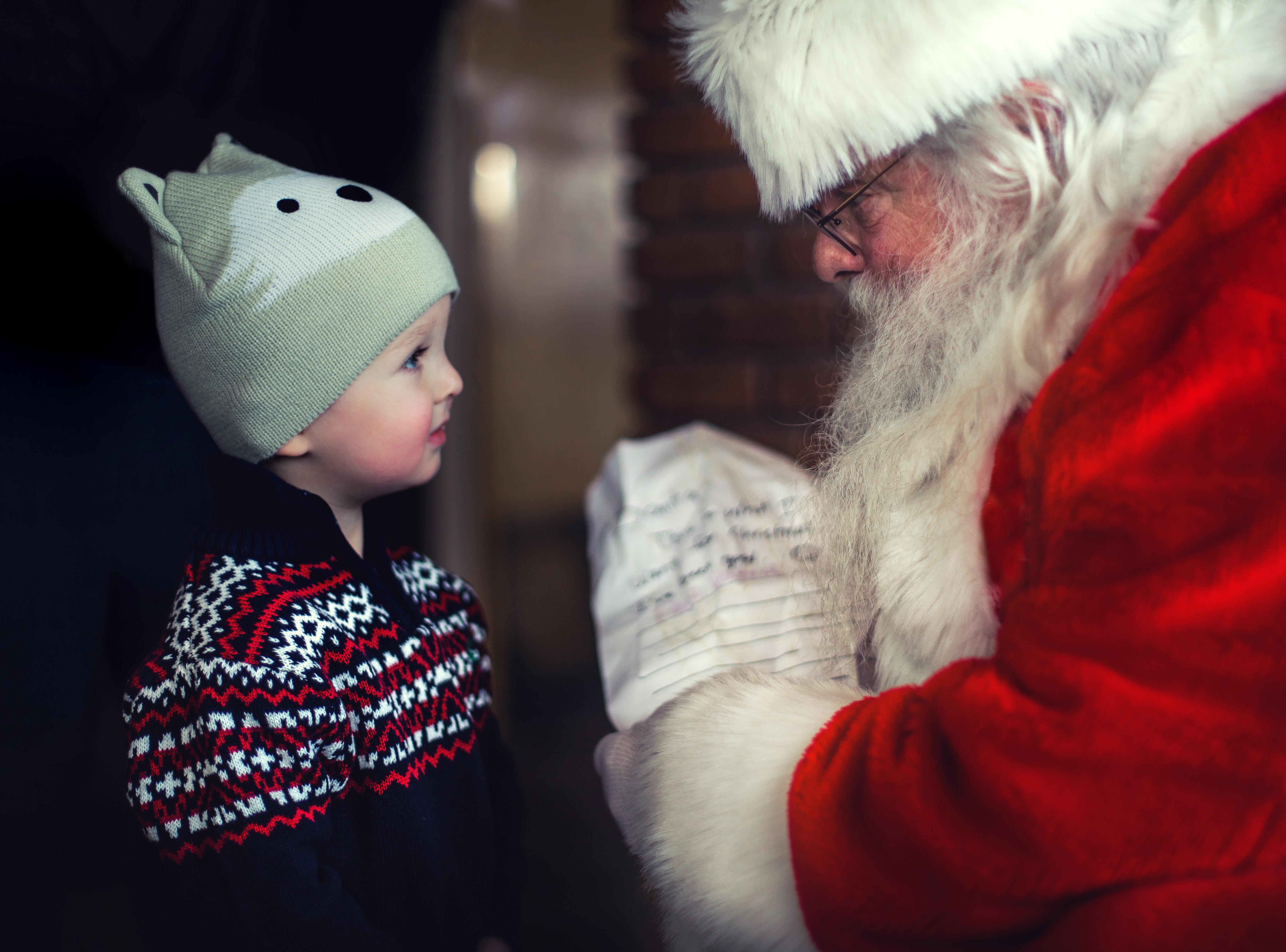 Father Christmas passing a present to a young boy