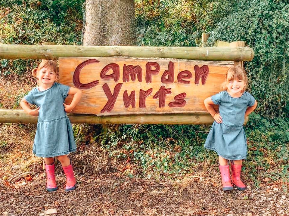 Campden Yurts sign with twins standing next to it