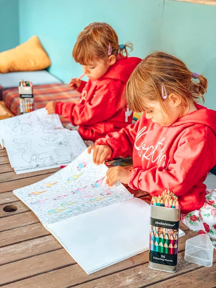 children colouring on a table