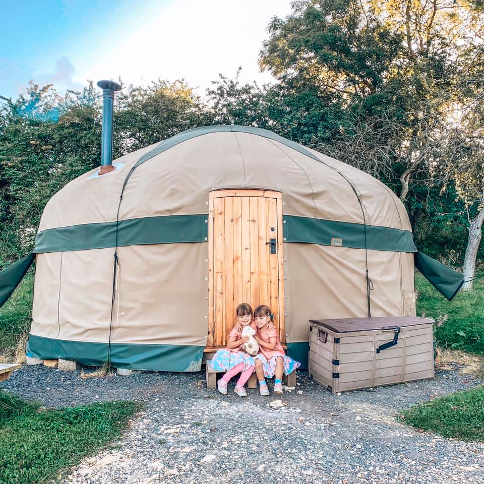 Campden Yurts with twin girls sitting by the door