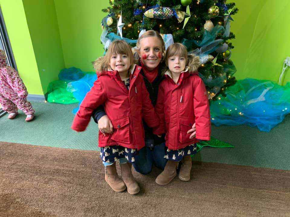 Twins and mummy in front of the Christmas tree at Bluestone - bluestone with a toddler