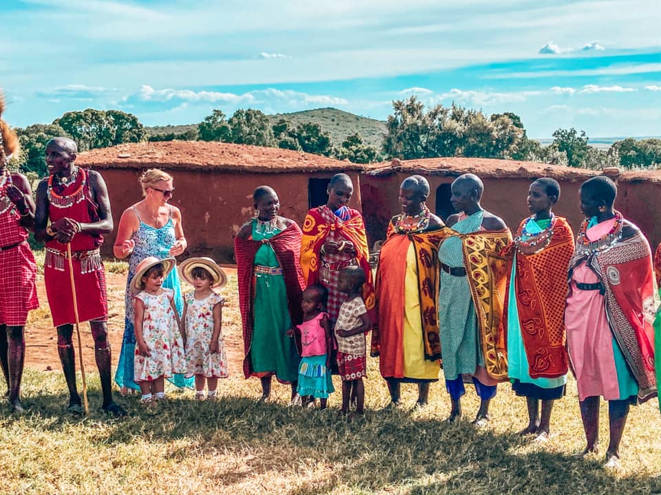 family learning a dance from the local community