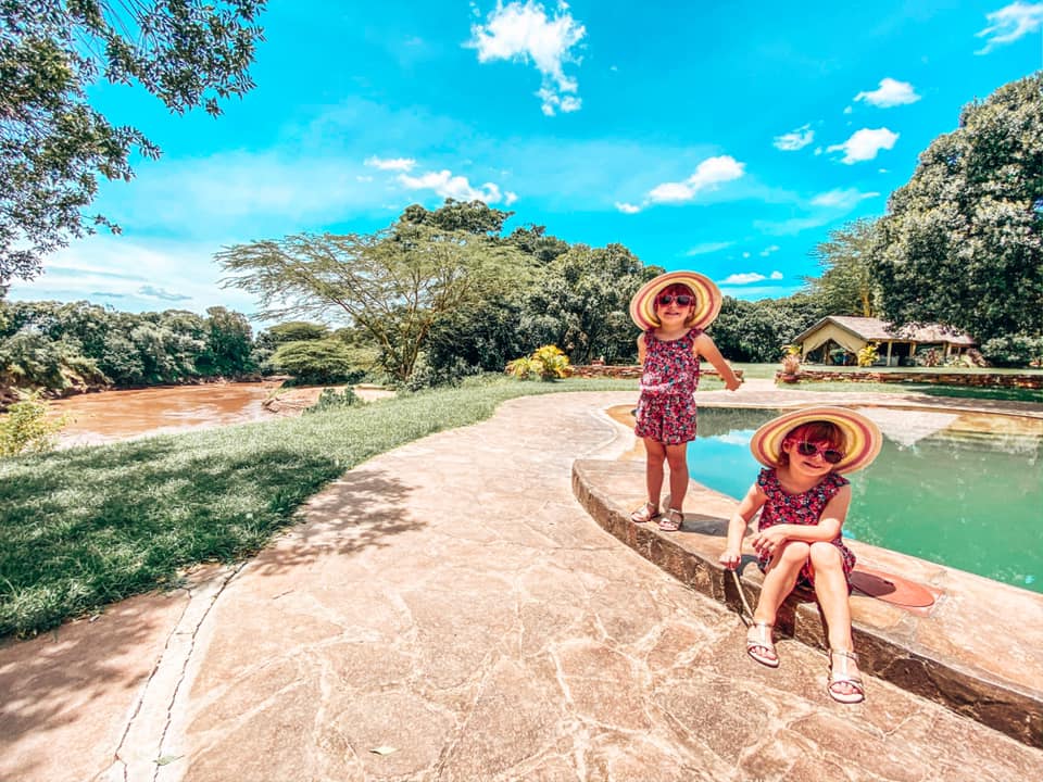 twins sat alongside a pool in House in the Wild at Maasai Mara