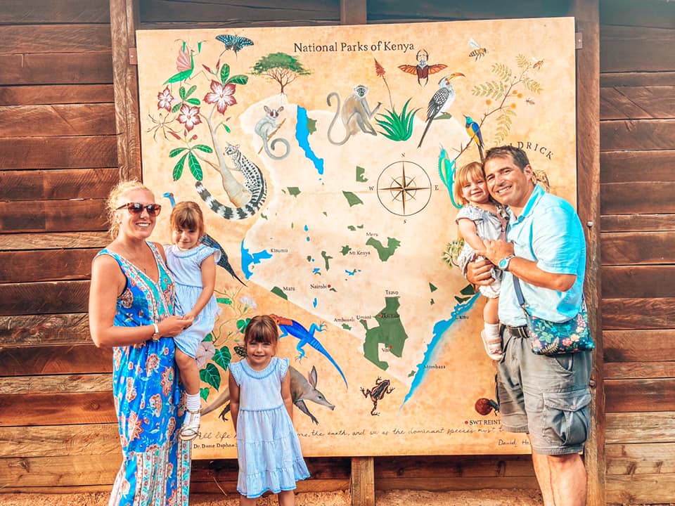 image of family in front of map of national parks of kenya