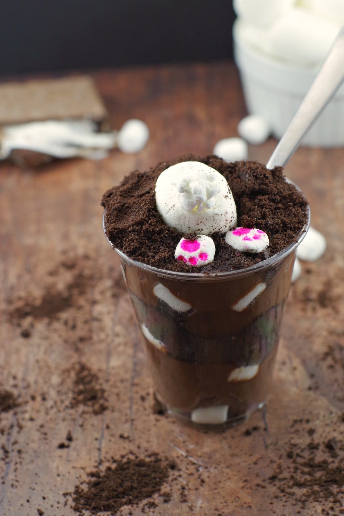 plastic cup filled with chocolate cake and an bunny bottom sticking out of the top