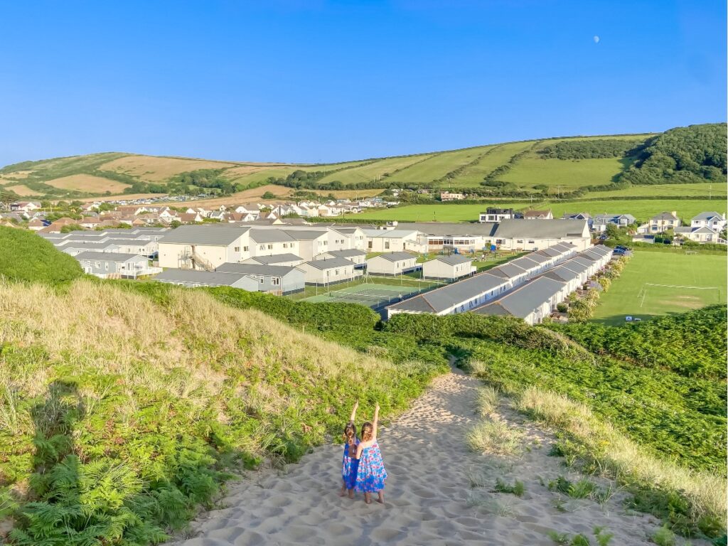 Children walking up the dunes at Croyde Bay beach