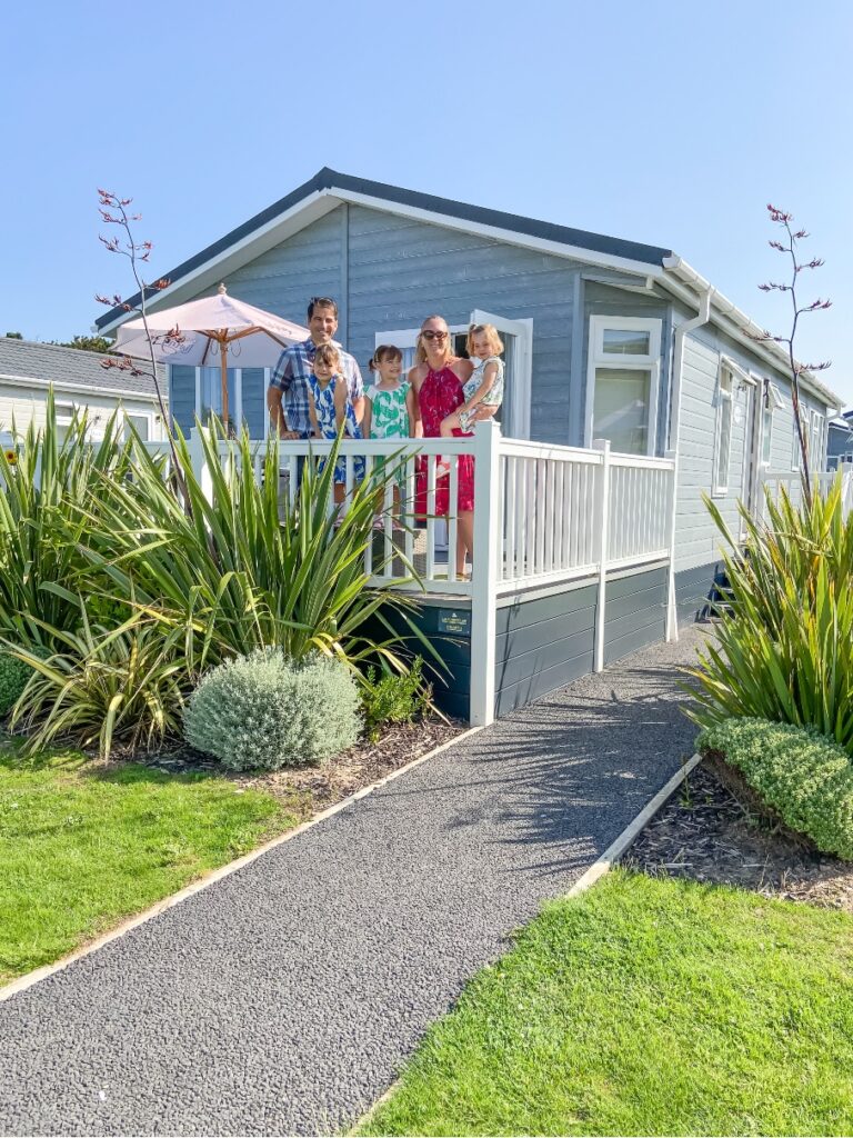 Croyde Bay Resort lodge with family standing on decking