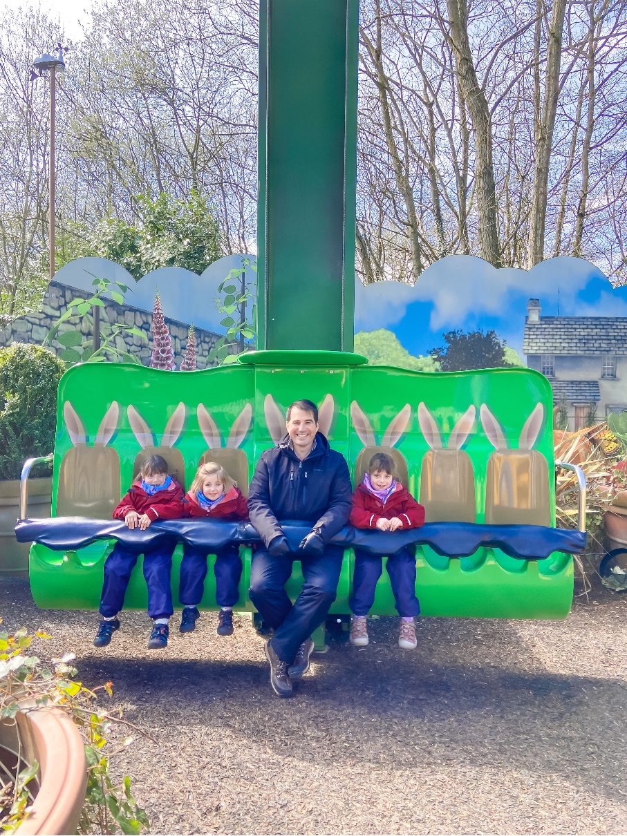 Alton Towers Cbeebies Land Peter Rabbit Ride - three girls and their daddy strapped in ready to go