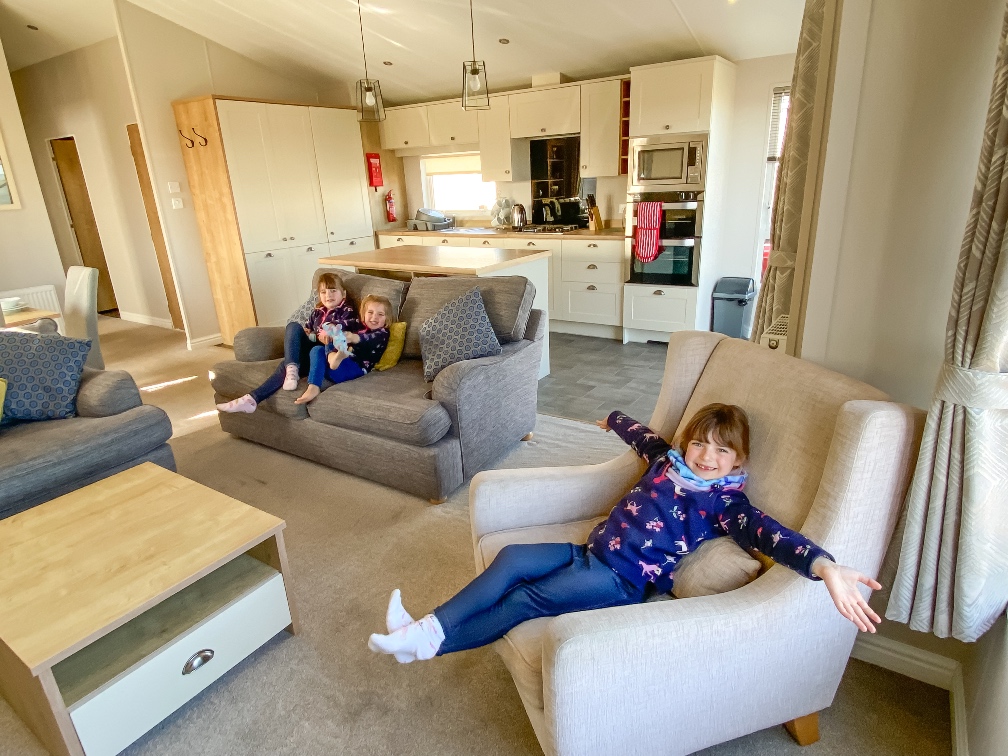 Away Resorts Golden Sands Rhyl three little girls sitting on beige sofas in the lodge