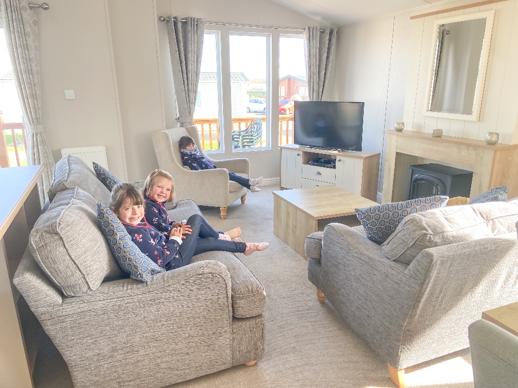 Away Resorts Golden Sands Rhyl the living area of the lodge. 3 little girls sitting on the sofa