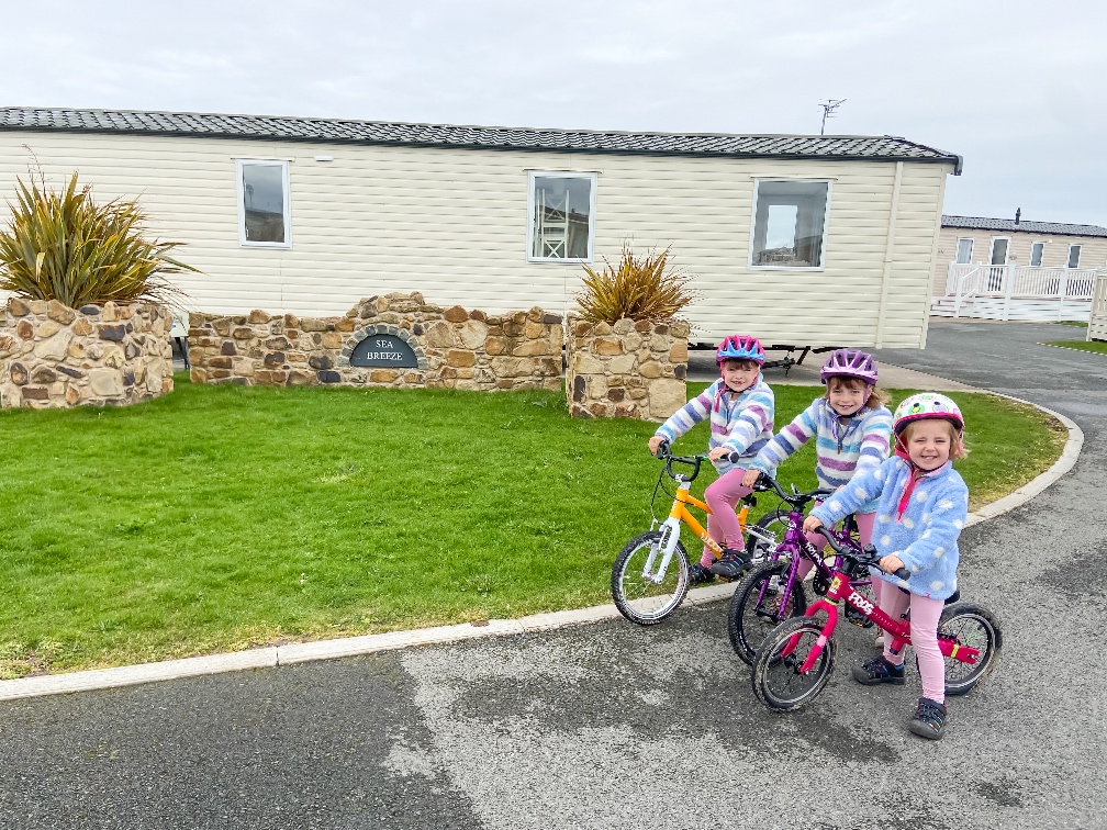 Away Resorts Golden Sands Rhyl 3 girls cycling on the resort