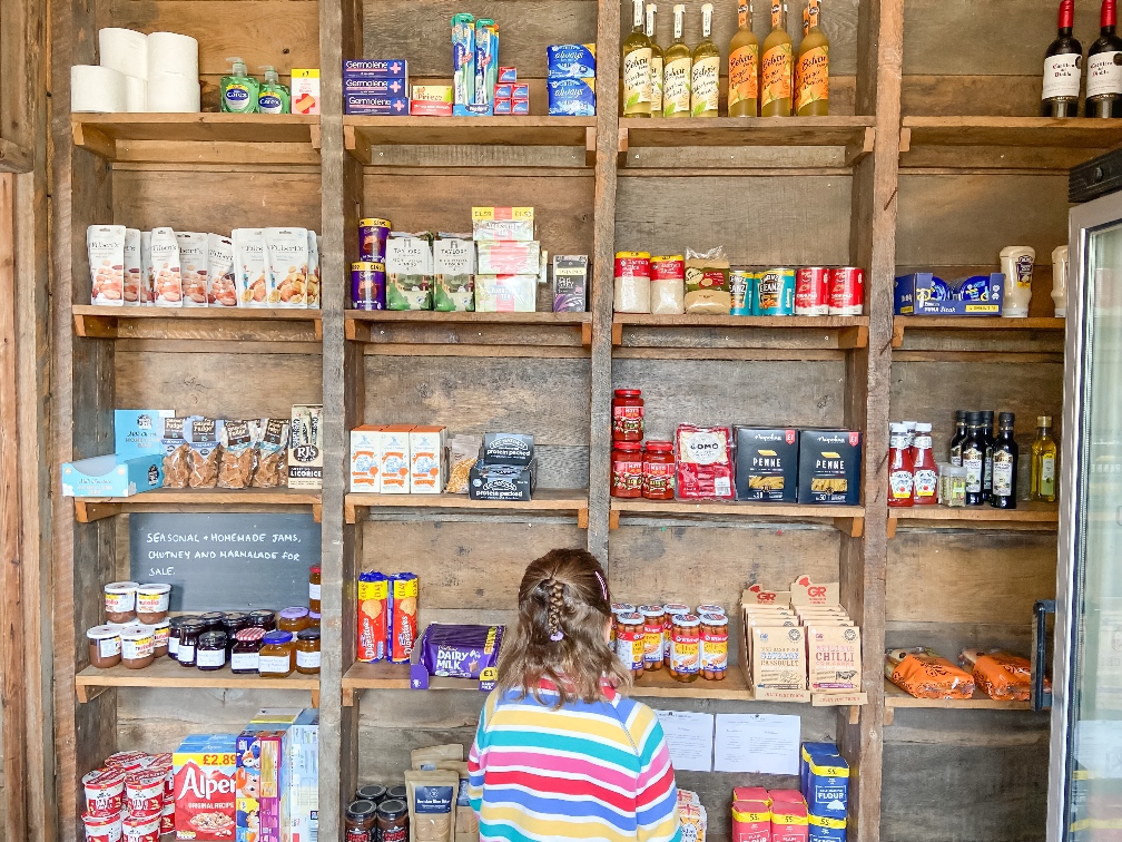 Glamping in Bedfordshire Featherdown honesty shop with little girls looking at produce