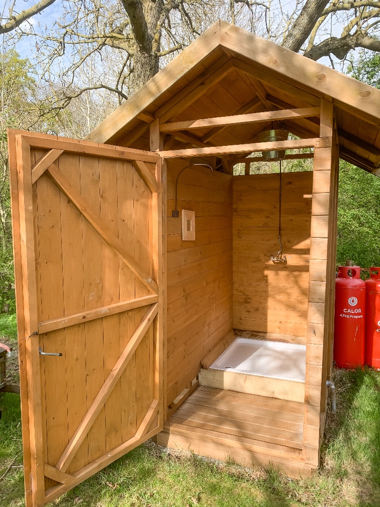 Glamping in Bedfordshire Featherdown the outdoor shower in a shed