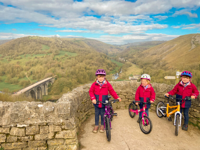 Bike subscription front view of bikes and hills in the distance with 3 girls