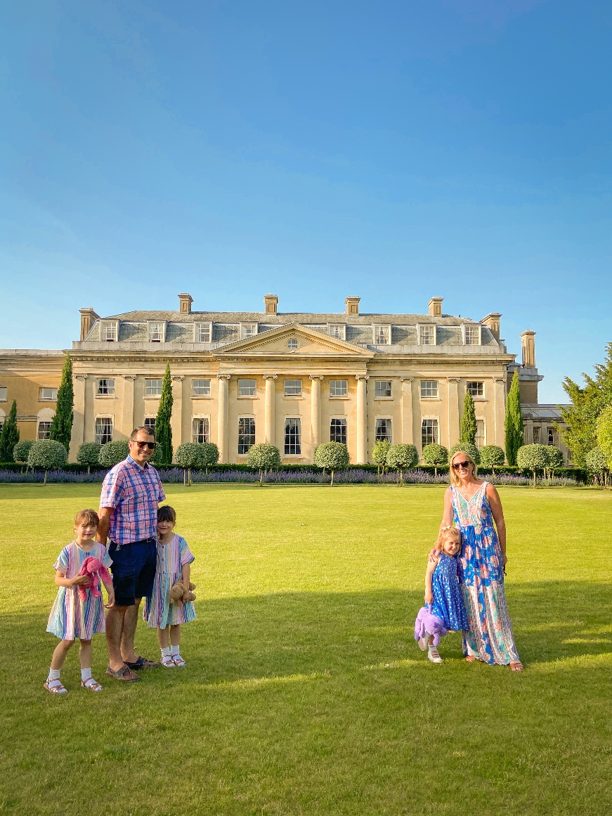 The Ickworth Hotel back of house with a family standing in front