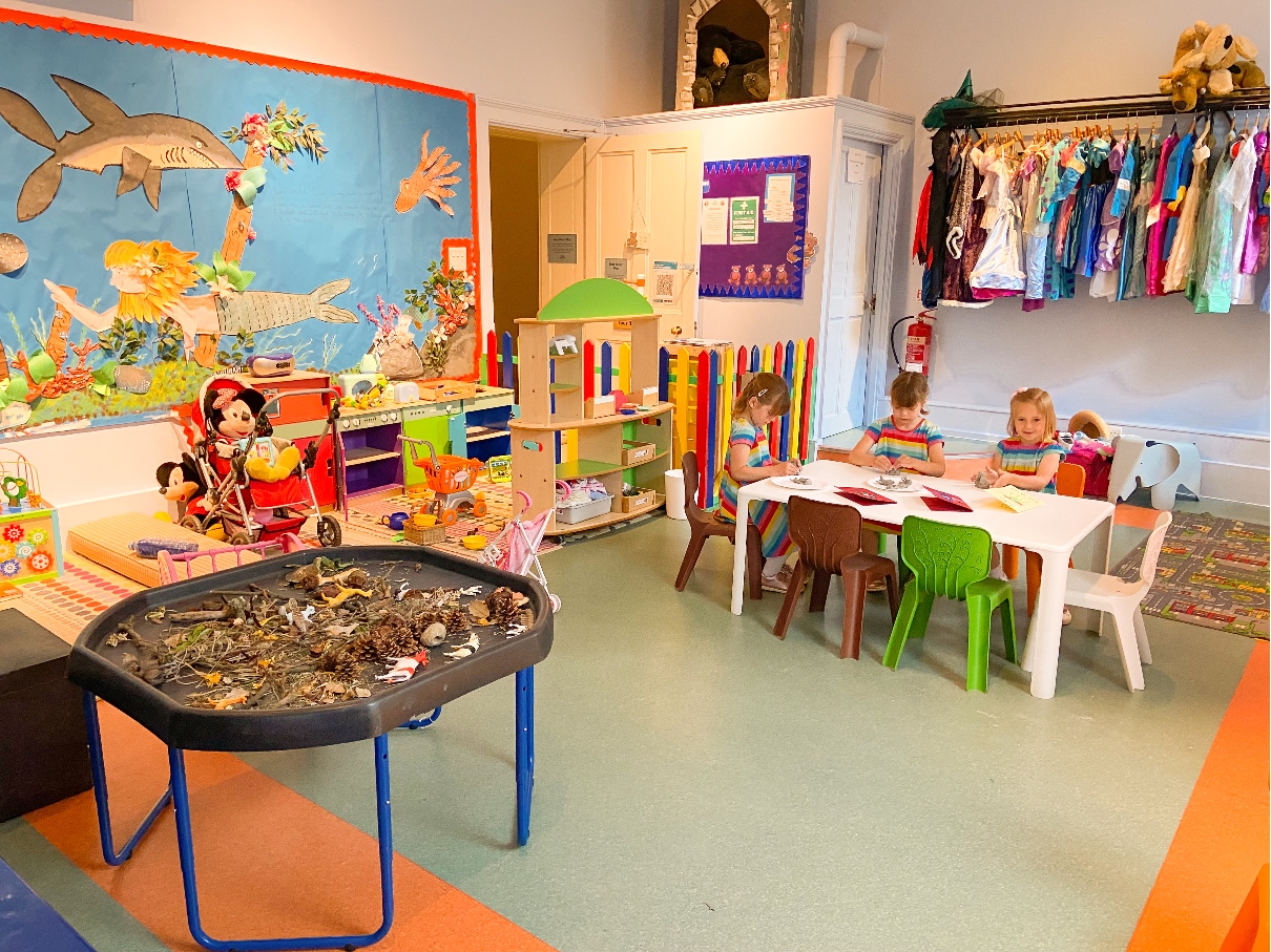 The Ickworth Hotel kids club - the den. A playroom full of toys with three young girls