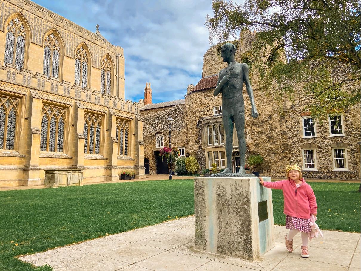 Bury St Edmunds Cathedral child standing in front of St Edmund statue