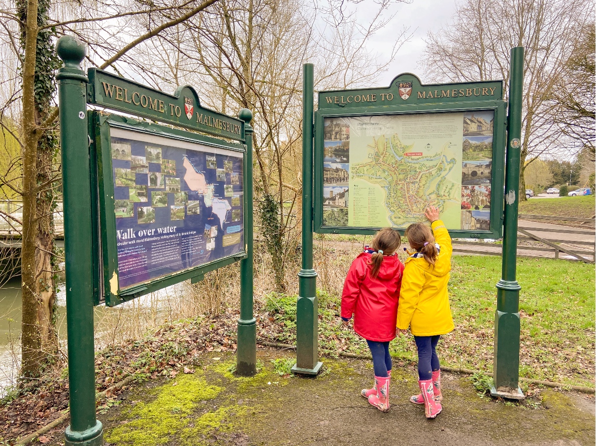 Malmesbury Map two girls in red and yellow coats looking at the map