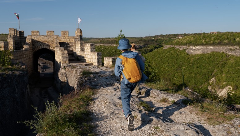 Hikers walking toward stone fortress overlook